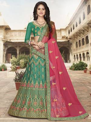 Grab This Heavy Designer Lehenga Choli In Green Color Paired With?Contrasting Rani Pink Colored Dupatta. Its Blouse Is Fabricated On Art Silk Paired With Satin Silk Fabricated Lehenga And Net Dupatta. Its Pretty Blouse And Lehenga Are Beautified With Embroidery Which Comes With A Net Dupatta With Lace Border. Buy Now