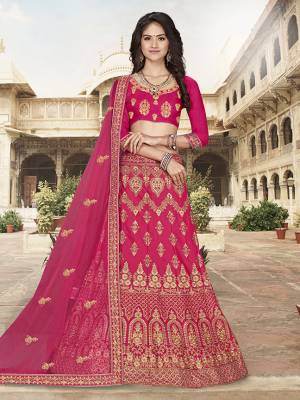 Here Is A Very Pretty Heavy Designer Lehnega Choli In All Over Dark Pink Color. Its Embroidered Blouse Is Fabricated On Art Silk Paired With Satin Silk Fabricated Lehenga And Net Fabricated Dupatta. All Its Fabrics Enusres Superb Comfort Throughout The Gala.