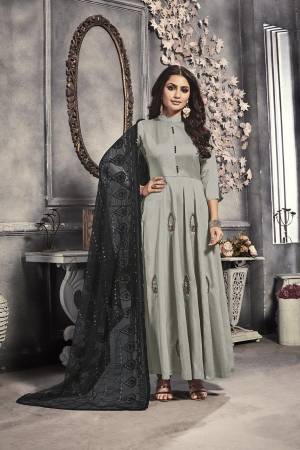 Add This Beautiful Designer Readymade Long Suit To Your Wardrobe In Grey Colored Top Paired With Black Colored Heavy Embroidered Dupatta. This Top Is Fabricated On Satin Paired With Net Fabricated Dupatta. 