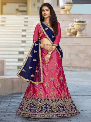 For A Proper Traditional Look, Grab This Heavy Designer Lehenga Choli In Pink Color Paired With Contrasting Navy Blue Colored Blouse. Its Blouse Is Fabricated On Art Silk Paired With Satin Silk Lehenga And Net Fabricated Dupatta. It Is Beautified With Attractive Embroidery. Buy This Pretty Piece Now.