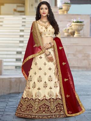 For A Proper Traditional Look, Grab This Heavy Designer Lehenga Choli In Cream Color Paired With Contrasting Red Colored Blouse. Its Blouse Is Fabricated On Art Silk Paired With Satin Silk Lehenga And Net Fabricated Dupatta. It Is Beautified With Attractive Embroidery. Buy This Pretty Piece Now.