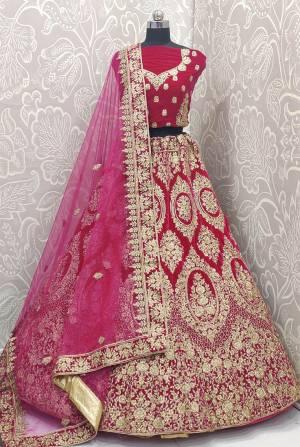 Here Is A Very Beautiful and Heavy Bridal Lehenga Choli In All over Rani Pink Color. This Lehenga Choli Is Fabricated on Velvet Paired With Net Fabricated Dupatta. It Is Beautified With Heavy Embroidery Which Will Earn You Lots of Compliments From Onlookers. 