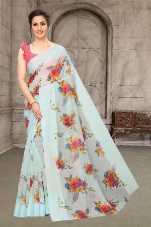 Simple And Elegant Looking Designer Saree In Here In Aqua Blue Color Paired With Red Colored Blouse. This Saree And Blouse Are Fabricated On Linen Cotton Beautified With Floral Prints All Over. Its Soft Rich Fabric And Elegant Color Will Give A Rich look To Your Personality. 