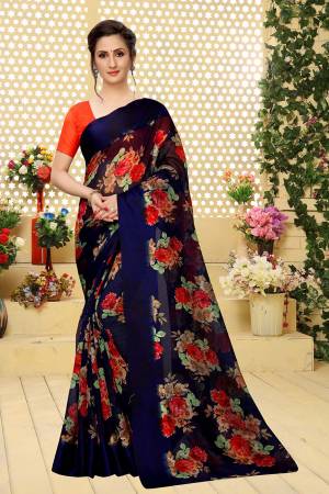 Here Is A Very Pretty And Elegant Looking Designer Saree In Navy Blue Color Paired With Orange Colored Blouse. This Saree And Blouse Are Linen Cotton Based Beautified With Pretty Floral Prints. It Is Light Weight, Durable And Easy To Carry All Day Long. 