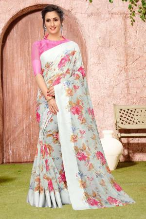 Celebrate This Festive Season With Beauty And Comfort Wearing This Pretty Floral Printed Designer Saree In Pastel Green Color Paired With Pink Colored Blouse. This Saree And Blouse Are Fabricated on Linen Cotton Which Is Durable And Easy To Care For. 