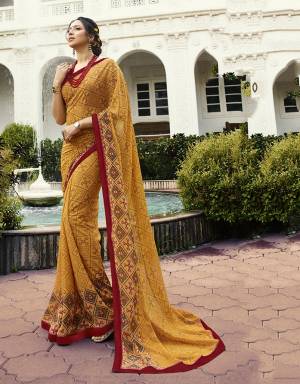Celebrate This Festive Season With Beauty And Comfort Wearing This Designer Printed Saree In Musturd Yellow Color Paired With Red Colored Blouse. This Saree Is Georgette Based Paired With Art Silk Fabricated Blouse. It Is Light In Weight And Easy To Carry All Day Long. 