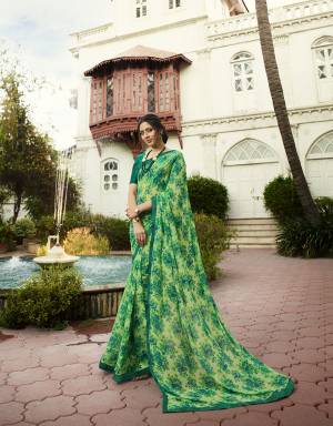 Here Is A Pretty Printed Saree In Green Color Paired With Teal Green Colored Blouse. This Saree Is Fabricated On Georgette Paired With Art Silk Fabricated Blouse. It Is Light Weight And Easy To Carry All Day Long. 