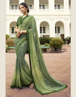 Here Is A Pretty Printed Saree In Light Green Color Paired With Green Colored Blouse. This Saree Is Fabricated On Georgette Paired With Art Silk Fabricated Blouse. It Is Light Weight And Easy To Carry All Day Long. 