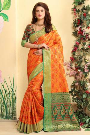 Grab This Attractive Looking Heavy Weaved Designer Saree In Orange Color Paired With Green Colored Blouse. This Saree And Blouse Are Fabricated Patola Jacquard Silk  Beautified With Weave All over. 