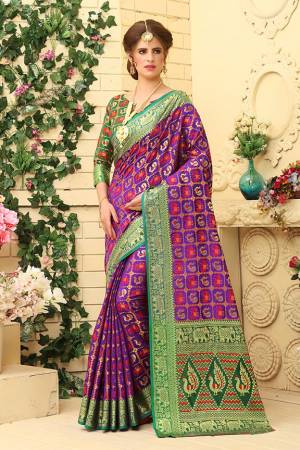 Here Is A Prefectly Suitable Designer Silk Based Saree For The Upcoming Festive And Wedding Season. This Pretty Saree In Purple Color Paired With Green Colored Blouse. This Saree And Blouse Are Fabricated Patola Jacquard Silk Beautified Attractive Detailed Weave All over. Buy This Rich Designer Saree Now.