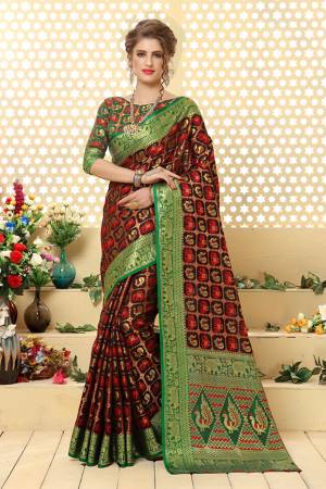Here Is A Prefectly Suitable Designer Silk Based Saree For The Upcoming Festive And Wedding Season. This Pretty Saree In Dark Brown Color Paired With Green Colored Blouse. This Saree And Blouse Are Fabricated Patola Jacquard Silk Beautified Attractive Detailed Weave All over. Buy This Rich Designer Saree Now.