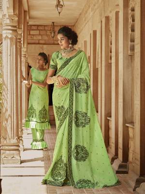 Add This Very Beautiful Heavy Designer Saree To Your Wardrobe In Light Green For The Upcoming Festive And Wedding Season. This Saree Is Fabricated On Satin Georgette Paired With Art Silk Fabricated Blouse. Buy Now. 
