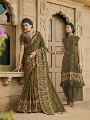 New Shade Is Here To Add Into Your Wardrobe With This Heavy Designer Saree In Olive Green Color Paired With Olive Green Colored Blouse. This Saree Is Fabricated On Satin Silk Paired With Art Silk Fabricated Blouse. 
