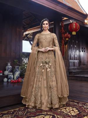 Look Pretty In This Designer Indo Western Dress In All Over Beige Color. Its Gown IS Fabricated On Satin Paired With Embroidered Net Fabricated Jacket With Santoon Bottom And Net Dupatta. 