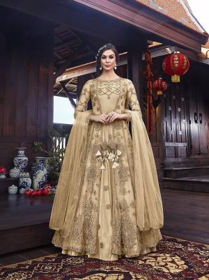 Look Pretty In This Designer Indo Western Dress In All Over Cream Color. Its Gown IS Fabricated On Satin Paired With Embroidered Net Fabricated Jacket With Santoon Bottom And Net Dupatta. 