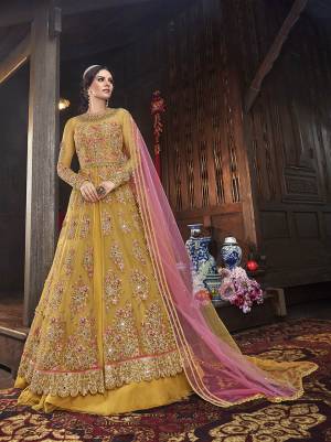 Get Ready Fot The Upcoming Festive And Wedding Season With This Designer Indo Western Suit With Two Bottom,In Musturd Yellow Color Paired With Contrasting Pink Colored Dupatta. Its Heavy Embroidered Top Is Fabricated On Net Paired With Art Silk Lehenga And Net Dupatta. Also It Comes With A Very Pretty Embroiderd Art Silk Fabricated Pant. 