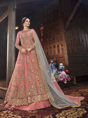 Get Ready Fot The Upcoming Festive And Wedding Season With This Designer Indo Western Suit With Two Bottom,In Dark Peach Color Paired With Contrasting Grey Colored Dupatta. Its Heavy Embroidered Top Is Fabricated On Net Paired With Art Silk Lehenga And Net Dupatta. Also It Comes With A Very Pretty Embroiderd Art Silk Fabricated Pant. 