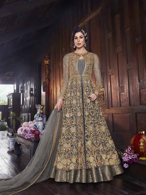 Flaunt Your Rich And Elegant Taste In This Lovely Designer Indo-Western Suit In Grey Color. It Has Elegant Looking Floor Length Gown Fabricated on Art Silk With Embroidered Net Fabricated Jacket Paired With Art Silk Fabricated bottom And Net Dupatta. 