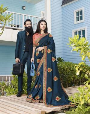Catch All The Limelight At The Next Function You Attend Wearing This Lovely Designer Saree In Teal Blue Color Paired With Dark Peach Colored Blouse. This Pretty Embroidered Saree Is Fabricated On Art Silk Paired With Jacquard Silk Fabricated Blouse. 