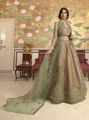 Get Ready For Upcoming Wedding Season Wearing This Heavy Designer Lehenga Choli In Light Olive Green Color. Its Blouse, Jacket And Lehenga Are Fabricated On Jacquard Silk And Net Paired With Net Fabricated Dupatta. It Is Beautified With Heavy Embroidery And Its Unique Jacket Pattern Will Earn You Lots Of Compliments From Onlookers .