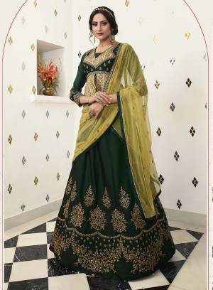 New And Unique Patterned Heavy Designer Lehenga Choli Is Here In Dark Green Color Paired With Pear Green Colored Dupatta. This Lehenga Choli Is Soft Silk Based Paired With Net Fabricated Dupatta, Also Its Blouse Is Highlighted With Printed Satin Fabric. 