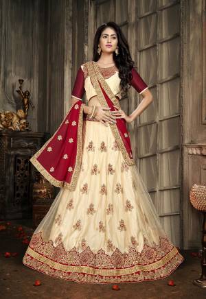 Here Is A Heavy Designer Lehenga Choli In Cream And Maroon. Its Blouse Is Fabricated On Art Silk Paired With Jacquard Net Fabricated Lehenga And Chiffon Dupatta. Its Pretty Blouse , Lehenga And Dupatta Are Beautified With Embroidery. Buy Now.