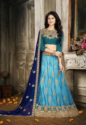For A Proper Traditional Look, Grab This Heavy Designer Lehenga Choli In Shades Of Blue Color. Its Blouse Is Fabricated On Art Silk Paired With Jacquard Net Lehenga And Chiffon Fabricated Dupatta. It Is Beautified With Attractive Embroidery. Buy This Pretty Piece Now.