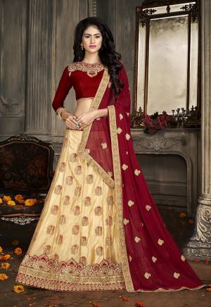Here Is A Heavy Designer Lehenga Choli In Maroon And Cream. Its Blouse Is Fabricated On Art Silk Paired With Jacquard Net Fabricated Lehenga And Chiffon Dupatta. Its Pretty Blouse , Lehenga And Dupatta Are Beautified With Embroidery. Buy Now.