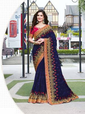 Celebrate This Festive And Wedding Season Wearing This Beautiful Heavy Designer Saree In Navy Blue Color Paired With Dark Pink Colored Blouse. This Saree Is Fabricated On Georgette Paired With Art Silk Fabricated Blouse. Buy Now. 