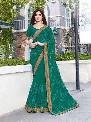 You Will Definitely Earn Lots Of Compliments Wearing This Heavy Designer Saree In Sea Green Color Paired With Sea Green Colored Blouse. This Pretty Heavy Embroidered Saree Is Georgette Based Paired With Art Silk Fabricated Blouse. 