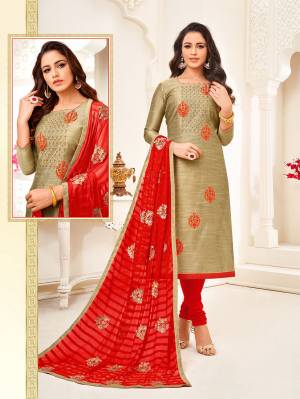 Add This Pretty Straight Suit To Your Wardrobe In Beige Colored Top Paired With Red Colored Bottom And Dupatta. Its Top Is Fabricated On Art Silk Paired With Cotton Bottom And Chiffon Fabricated Dupatta. 
