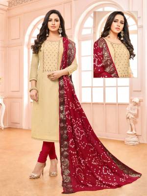 Grab This Lovely Color Pallete With This Designer Suit In Cream Colored Top Paired With Red Colored Bottom And Dupatta. Its Top Is Modal Based Paired With Cotton Bottom And Bandhani Jacquard Fabricated Dupatta. 