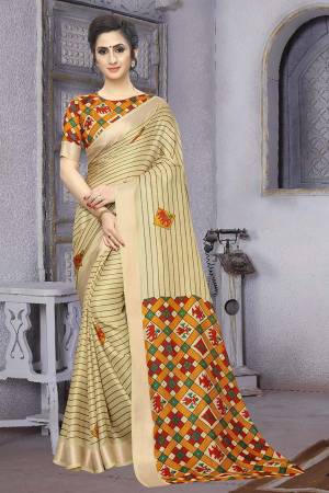 Celebrate This Festive With Beauty And Comfort Wearing This Rich Looking Saree In Cream Color Paired With Orange Colored Blouse. This Saree And Blouse Are Soft Cotton Based Beautified With Prints. 