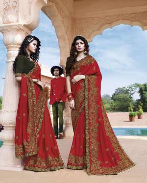 Celebrate This Festive And Wedding Season Wearing This Heavy Designer Saree In Red Color Paired With Contrasting Dark Green Colored Blouse. This Pretty Saree And Blouse Are Silk Based Beautified With Heavy Embroidery Work. 