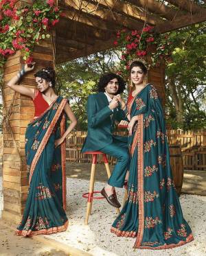 Add This Beautiful Heavy Designer Saree To Your Wardrobe In Teal Blue Color Paired With Red Colored Blouse. This Saree And Blouse Are Fabricated On Art Silk Beautified With Heavy Embroidery. 