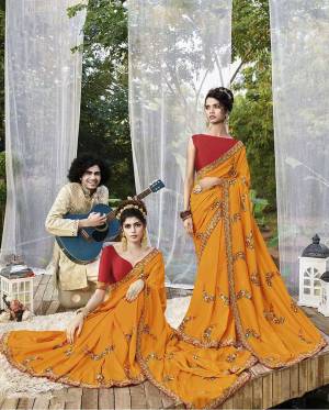 Add This Beautiful Heavy Designer Saree To Your Wardrobe In Musturd Yellow Color Paired With Red Colored Blouse. This Saree And Blouse Are Fabricated On Art Silk Beautified With Heavy Embroidery. 