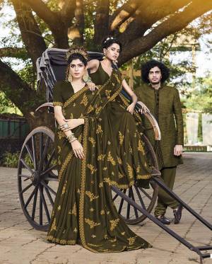 Celebrate This Festive And Wedding Season Wearing This Heavy Designer Saree In Dark Olive Green Color Paired With Dark Olive Green Colored Blouse. This Pretty Saree And Blouse Are Silk Based Beautified With Heavy Embroidery Work. 