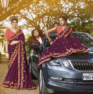 Celebrate This Festive And Wedding Season Wearing This Heavy Designer Saree In Purple Color Paired With Contrasting Dark Peach Colored Blouse. This Pretty Saree And Blouse Are Silk Based Beautified With Heavy Embroidery Work. 