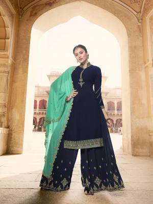 For A Bold And Beautiful Look, Grab This Heavy Designer Suit In Navy Blue Color Paired With Sea Green Colored Dupatta. Its Top, bottom And Dupatta Are Fabricated On Georgette Beautfied With Embroidery. Buy This Semi-Sitched Suit Now.