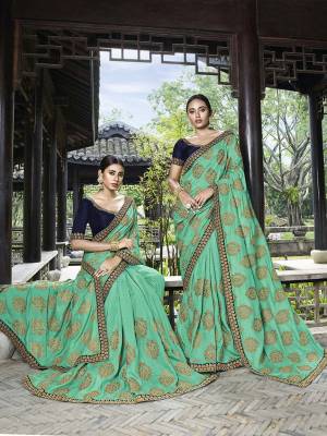 Add This Beautiful Heavy Designer Saree To Your Wardrobe In Sea Green Color Paired With Navy Blue Colored Blouse. This Saree And Blouse Are Fabricated On Art Silk Beautified With Heavy Embroidery. 