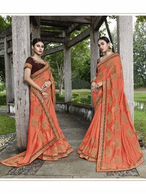 Add This Beautiful Heavy Designer Saree To Your Wardrobe In Orange Color Paired With Red Colored Blouse. This Saree And Blouse Are Fabricated On Art Silk Beautified With Heavy Embroidery. 