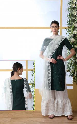 Flaunt Your Rich And Elegant Taste Wearing This Very Pretty And Elegant Looking Designer Suit In Pine Green Colored Top Paired With White Colored Bottom And Dupatta. Its Top and Bottom Are Cotton Based Paired With Net Fabricated Heavy Embroidered Dupatta. 