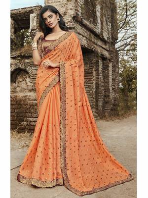 Attract All Wearing This Heavy Designer Saree In Orange Color Paired With Maroon And Gold Blouse. This Saree Is Fabricated On Satin Silk Paired With Jacquard Silk Fabricated Blouse. Buy This Saree Now.