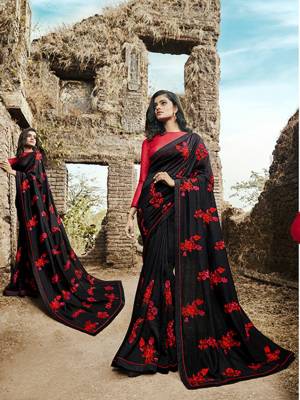 For A Royal Look, Grab This Heavy Designer Saree In Black Color Paired With Red Colored Blouse. This Saree And Blouse Are Silk Based Beautified With Contrasting  Attractive Embroidery. Buy This Saree Now.