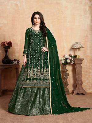 Here Is A Beautiful Heavy Designer Lehenga Suit In All Over Dark Green Color. Its Embroidered Top and Dupatta Are Fabricated On Georgette Paired With Jacquard Silk Fabricated Lehenga. It Beautiful Pattern and Color Will Definitely Earn You Lots Of Compliments From Onlookers. 