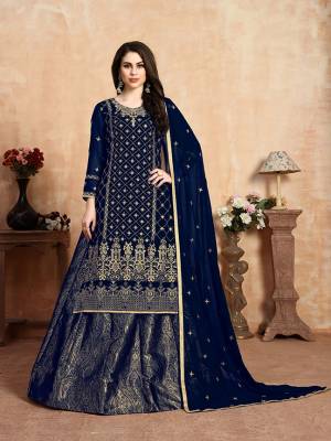 Here Is A Beautiful Heavy Designer Lehenga Suit In All Over Navy Blue Color. Its Embroidered Top and Dupatta Are Fabricated On Georgette Paired With Jacquard Silk Fabricated Lehenga. It Beautiful Pattern and Color Will Definitely Earn You Lots Of Compliments From Onlookers. 