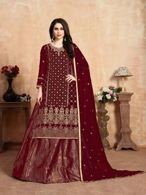Here Is A Beautiful Heavy Designer Lehenga Suit In All Over Maroon Color. Its Embroidered Top and Dupatta Are Fabricated On Georgette Paired With Jacquard Silk Fabricated Lehenga. It Beautiful Pattern and Color Will Definitely Earn You Lots Of Compliments From Onlookers. 
