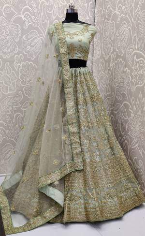 Look The Most Elegant Of All This Wedding Season Wearing This Heavy Designer Lehenga Choli In Pastel Green Color. This Beautiful Heavy Tone To Tone Embroidered Lehenga Choli Is Fabricated On Net. Its Rich Color and Detailed Embroidery Will earn You Lots Of Compliments From Onlookers 