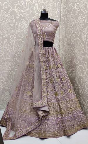 Look The Most Elegant Of All This Wedding Season Wearing This Heavy Designer Lehenga Choli In Mauve Color. This Beautiful Heavy Tone To Tone Embroidered Lehenga Choli Is Fabricated On Net. Its Rich Color and Detailed Embroidery Will earn You Lots Of Compliments From Onlookers 