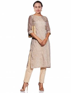 Beat The Heat This Summer With Cool Cotton Kurti With This Readymade Kurti In Beige Color Which Is Polyester Based. It Is Beautified With Lining Prints All Over. 
